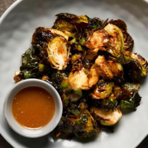 Crispy Sesame Brussels Sprouts Fried Brussels sprouts tossed with sesame dressing and topped with crispy onions.