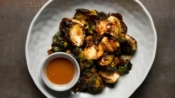 Crispy Sesame Brussels Sprouts Fried Brussels sprouts tossed with sesame dressing and topped with crispy onions.